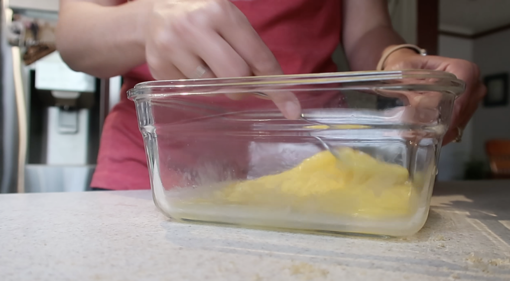 lady whisking eggs with a fork