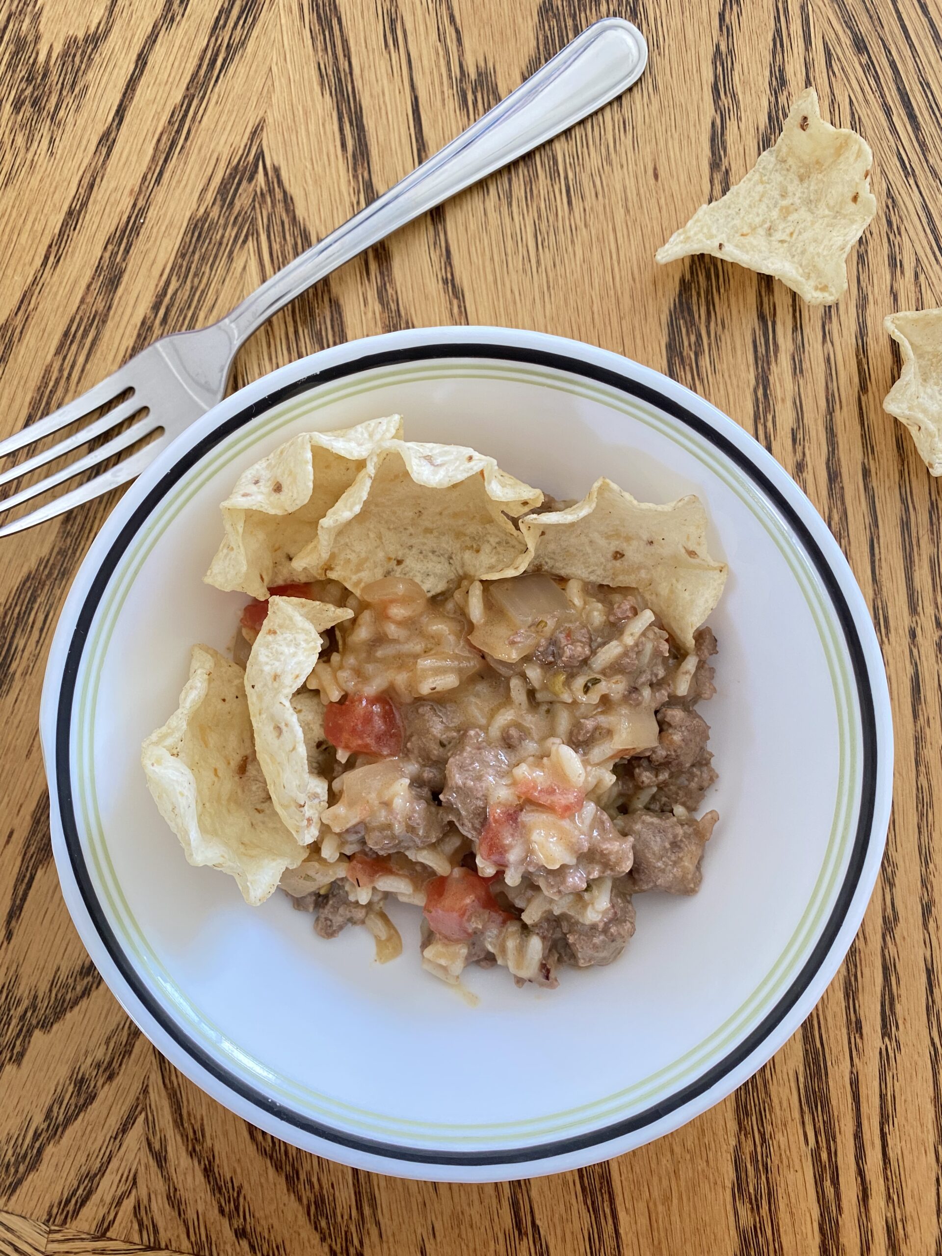 mexican rice with tortilla chips in a white bowl