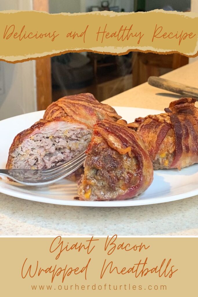 bacon wrapped meatballs on a white plate with a silver fork. The front meatball is cut in half.