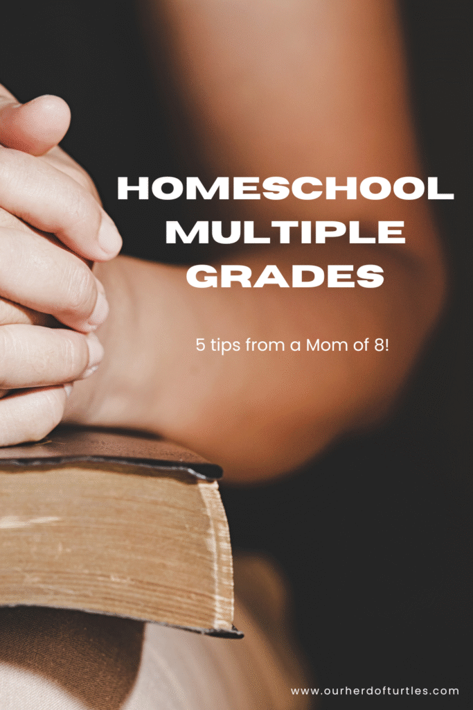 a person sitting with they hands folded on top of a bible that is sitting on their knee