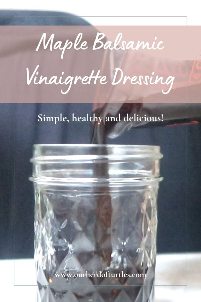 close up shot of a woman pouring maple balsamic vinaigrette into a small mason jar
