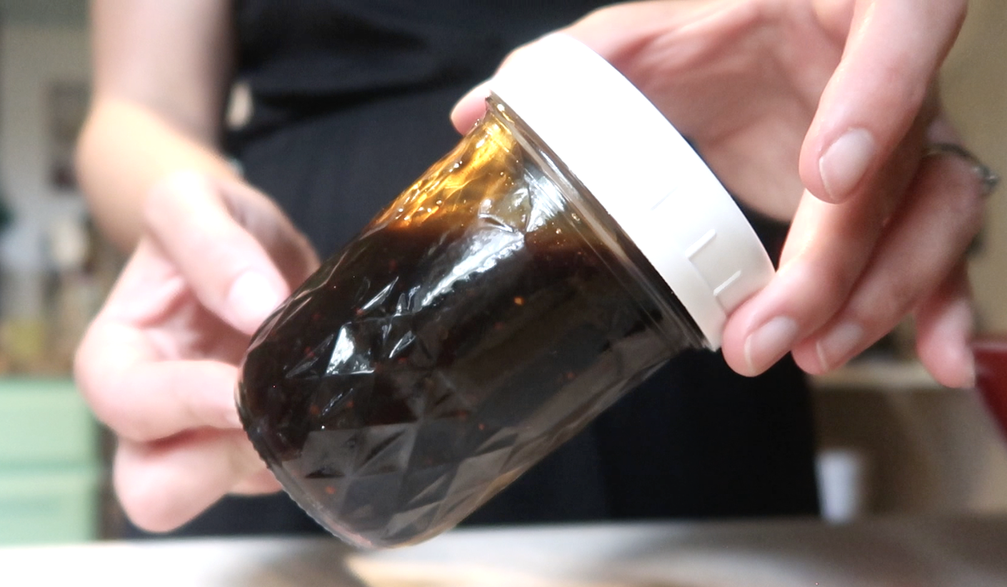 small jar of maple balsamic vinaigrette with a lid