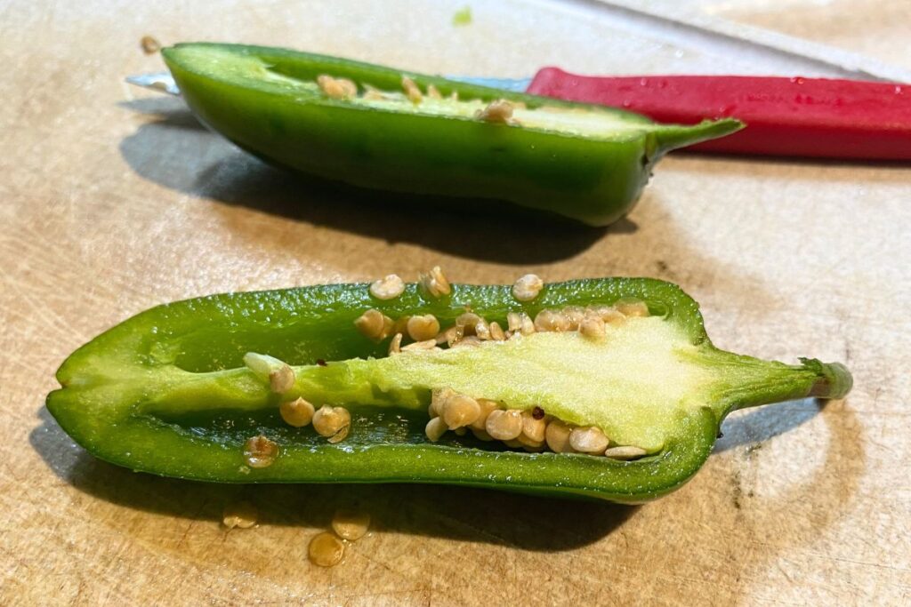 close up of a jalapeño sliced in half with the middle up