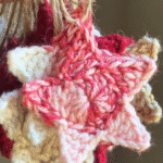 front view of a red and white crocheted star