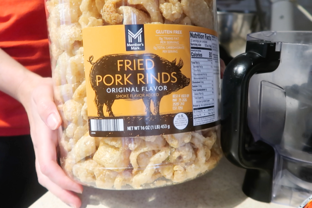 close up of large container of fried pork rinds