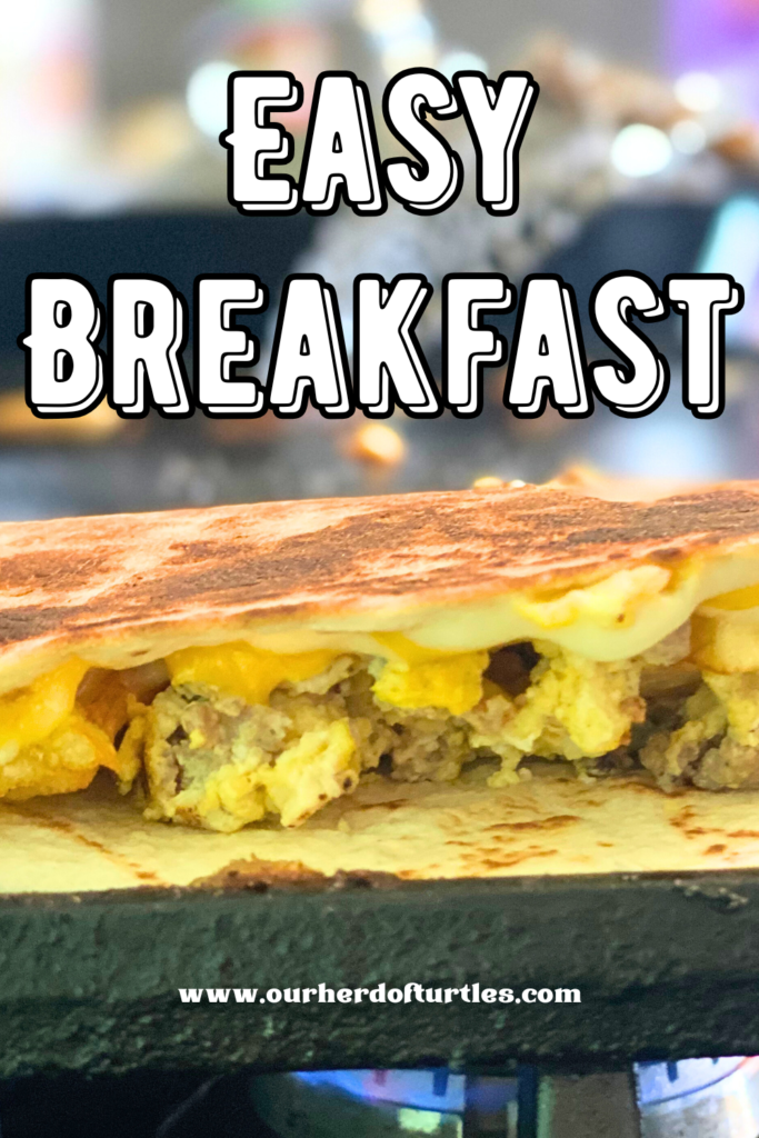 close up of a crunchy tortilla filled with scrambled eggs, sausage, potatoes and cheese.