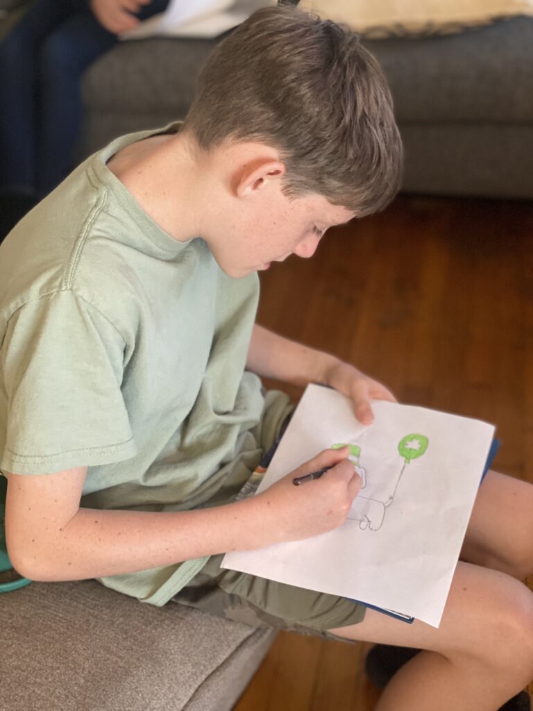 boy drawing on a piece of paper